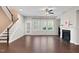 Spacious living room featuring a fireplace, large windows, and a staircase to the upper level at 425 Summit Trail Dr, Hillsborough, NC 27278