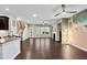 Open-concept living room with dark wood floors, modern light fixtures, and fireplace at 425 Summit Trail Dr, Hillsborough, NC 27278