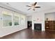 Cozy living room with dark wood floors, a fireplace, and bright natural light at 425 Summit Trail Dr, Hillsborough, NC 27278