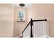 Close up view of the staircase leading to the upper level, with a decorative light fixture at 425 Summit Trail Dr, Hillsborough, NC 27278