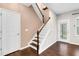 Staircase with wood and white railings, leading to the upper level of the home at 425 Summit Trail Dr, Hillsborough, NC 27278