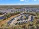 Wide aerial view of a residential community with numerous homes surrounded by lush greenery and trees at 4905 Abundance Ave, Raleigh, NC 27616