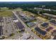 Aerial view of apartments with community amenities including a pool, playground, and pond in a suburban setting at 4905 Abundance Ave, Raleigh, NC 27616