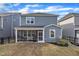 Exterior of the home showcasing a screened-in porch and a well-maintained lawn at 4905 Abundance Ave, Raleigh, NC 27616