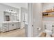 Bathroom with a modern vanity, shelving, and a toilet located in its own partitioned space at 4905 Abundance Ave, Raleigh, NC 27616