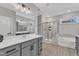 Elegant bathroom featuring a double vanity with a separate tiled tub and shower at 4905 Abundance Ave, Raleigh, NC 27616