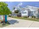 A beautiful white clubhouse with stone accents, lush landscaping, and a sign that says 'The Club 5401 North' at 4905 Abundance Ave, Raleigh, NC 27616