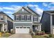 Charming two-story home with blue siding, stone accents, and a two-car garage in a well-kept neighborhood at 4905 Abundance Ave, Raleigh, NC 27616