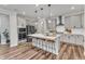 Modern kitchen features an island with seating, stainless steel appliances, and a subway tile backsplash at 4905 Abundance Ave, Raleigh, NC 27616