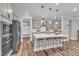 Contemporary kitchen boasts an island with seating, stainless steel appliances, and ample storage space at 4905 Abundance Ave, Raleigh, NC 27616