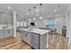 Spacious kitchen with island seating flows into dining and living areas, perfect for modern living at 4905 Abundance Ave, Raleigh, NC 27616