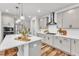 Bright kitchen featuring gray cabinets, stainless steel appliances, and a spacious quartz island at 4905 Abundance Ave, Raleigh, NC 27616