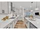 Gourmet kitchen features white countertops, sleek cabinetry, stainless steel appliances, and an open layout at 4905 Abundance Ave, Raleigh, NC 27616