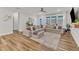Open living room with hardwood floors, sectional couch and a large window at 4905 Abundance Ave, Raleigh, NC 27616