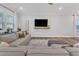 Comfortable living room features a sectional sofa, TV, and a large window at 4905 Abundance Ave, Raleigh, NC 27616