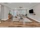 Spacious living room with hardwood floors, sectional couch and a large window at 4905 Abundance Ave, Raleigh, NC 27616