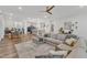 Living room with hardwood floors, sectional couch, dining room and open kitchen at 4905 Abundance Ave, Raleigh, NC 27616