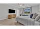 A bright, spacious bedroom features a TV, window and ceiling fan at 4905 Abundance Ave, Raleigh, NC 27616