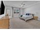A bright and spacious main bedroom with a fan, window, and TV at 4905 Abundance Ave, Raleigh, NC 27616