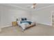 A neutral palette bedroom features a fan, tray ceiling, and side tables at 4905 Abundance Ave, Raleigh, NC 27616