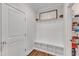 Mudroom with built in bench, coat hooks, and storage cubbies at 4905 Abundance Ave, Raleigh, NC 27616