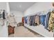 Spacious walk-in closet featuring ample storage space with shelving and hanging racks at 4905 Abundance Ave, Raleigh, NC 27616