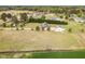Expansive aerial view showcases the home's setting on a large lot with mature trees and a well-manicured lawn at 495 Evans Rd, Princeton, NC 27569