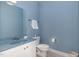 Bathroom features a blue countertop vanity, toilet, and ample space at 495 Evans Rd, Princeton, NC 27569
