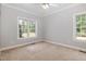 Bedroom with neutral walls, plush carpet, and an abundance of natural light at 495 Evans Rd, Princeton, NC 27569