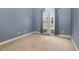 Bedroom with a arched window, neutral carpet, and modern gray walls at 495 Evans Rd, Princeton, NC 27569