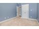 Bedroom featuring neutral carpet, paint and large closet at 495 Evans Rd, Princeton, NC 27569