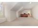 Spacious bonus room features neutral carpet, arched window with built-in bench, and access to additional rooms at 495 Evans Rd, Princeton, NC 27569