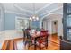 Elegant dining room featuring hardwood floors, tray ceiling, and stylish decor, perfect for entertaining guests at 495 Evans Rd, Princeton, NC 27569