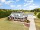 Stunning brick home featuring a charming front porch, lush lawn, and convenient detached garage at 495 Evans Rd, Princeton, NC 27569