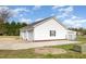 Exterior view of a detached two car garage with white siding and concrete driveway at 495 Evans Rd, Princeton, NC 27569