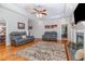 Cozy living room boasts hardwood floors, fireplace, tray ceiling, and neutral colors, creating a relaxing atmosphere at 495 Evans Rd, Princeton, NC 27569