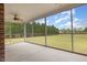 Relaxing screened porch with ceiling fan and views of the expansive, tree-lined backyard at 495 Evans Rd, Princeton, NC 27569