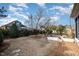 Backyard featuring a stone patio, mature trees, manicured shrubbery and lawn at 502 Sippihaw Oaks Dr, Fuquay Varina, NC 27526