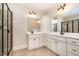 Primary bathroom featuring double sinks, white cabinets, walk-in shower with tile surround at 502 Sippihaw Oaks Dr, Fuquay Varina, NC 27526