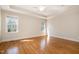 Spacious bedroom features hardwood floors, large windows, white trim and neutral color at 502 Sippihaw Oaks Dr, Fuquay Varina, NC 27526