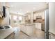 Bright kitchen featuring white cabinets, an island, stainless steel appliances, and tile floors providing a functional space at 502 Sippihaw Oaks Dr, Fuquay Varina, NC 27526
