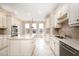 Eat-in kitchen with stainless steel appliances, tile floors, a large island and lots of windows at 502 Sippihaw Oaks Dr, Fuquay Varina, NC 27526