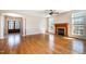 Bright living room featuring hardwood floors, fireplace, large windows, and decorative columns creating an inviting space at 502 Sippihaw Oaks Dr, Fuquay Varina, NC 27526