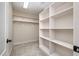 Walk-in closet featuring built-in shelving, carpeted floors, and neutral color at 502 Sippihaw Oaks Dr, Fuquay Varina, NC 27526