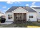 Backyard view showing a screened porch, a patio and a section of grass at 517 Edenfield Dr, Fuquay Varina, NC 27526
