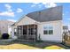 Exterior shot displaying backyard with a screened porch and a partial lawn at 517 Edenfield Dr, Fuquay Varina, NC 27526