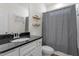 Well-lit bathroom features a vanity with a granite countertop and a shower with a gray curtain at 517 Edenfield Dr, Fuquay Varina, NC 27526