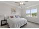 Bedroom with tray ceiling and ceiling fan boasts a large window and natural light at 517 Edenfield Dr, Fuquay Varina, NC 27526