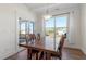 Dining room featuring wood floors, a large window, and access to the screened-in porch at 517 Edenfield Dr, Fuquay Varina, NC 27526