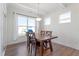 Bright dining room features modern light fixture, wood floors, and a large window at 517 Edenfield Dr, Fuquay Varina, NC 27526